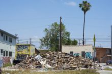 This image displays a destroyed building post-disaster.