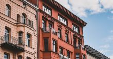 Three brick building against a blue sky