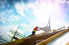 A construction worker building a green safe home.