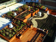 Aerial view of a rooftop garden featuring wood planters 