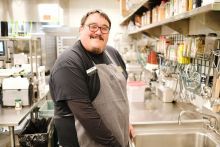 Brandon Adkins stands in front of sink