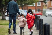 Father walking with two girls