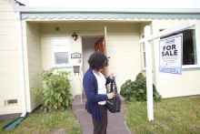 Woman in front of home for sale