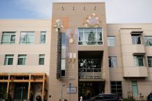 Two-tone beige apartment building with splashes of color