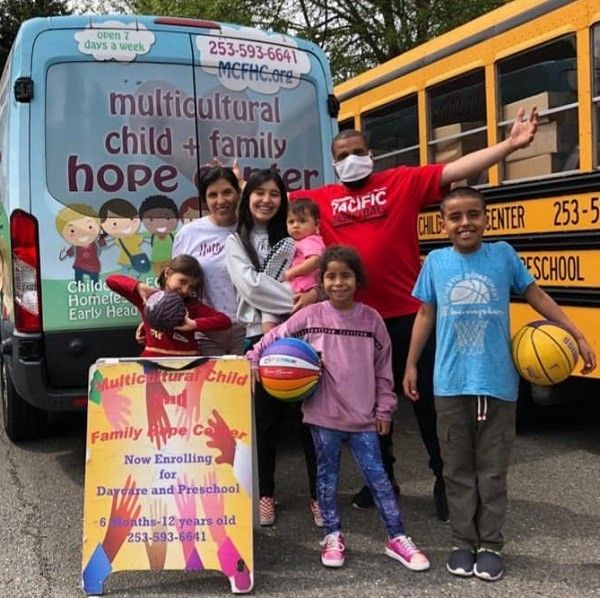 volunteers standing in front of Hope Center buses.