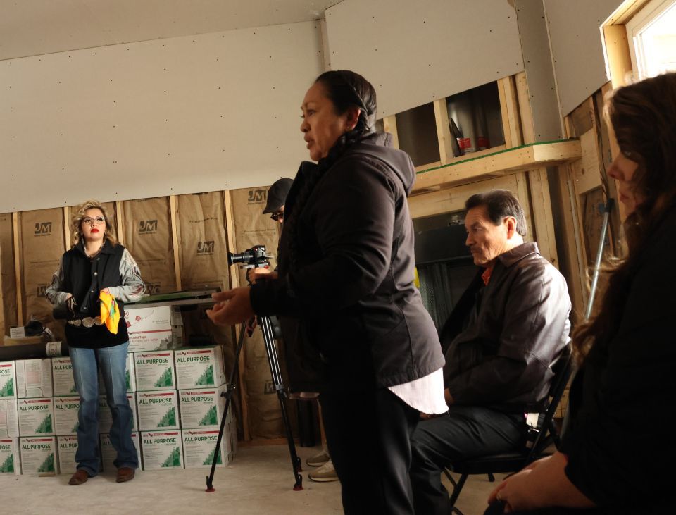 Greta Armijo talks to a group touring new housing at the Pueblo of Jemez