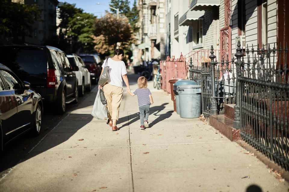 Woman and child walking on a street in New York