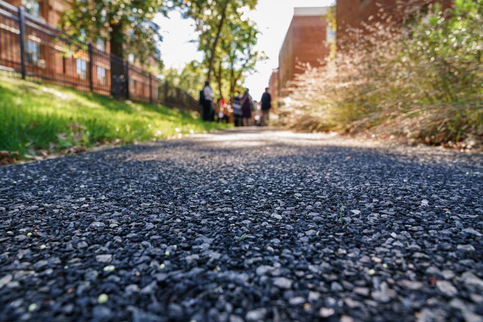 Close up of permeable paving with brick housing development in the background