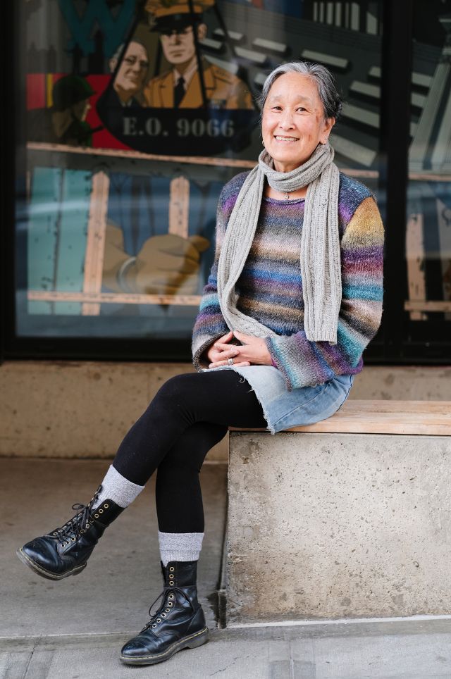 Leslie Morishita, real estate development director at InterIm CDA, sitting in front of Hirabayashi Place