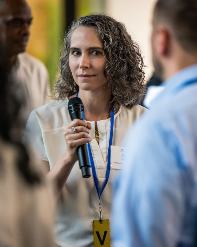 Person standing with microphone in hand