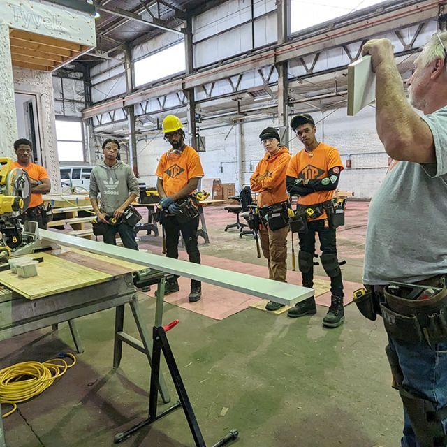 Factory workers receiving instructions from the manager