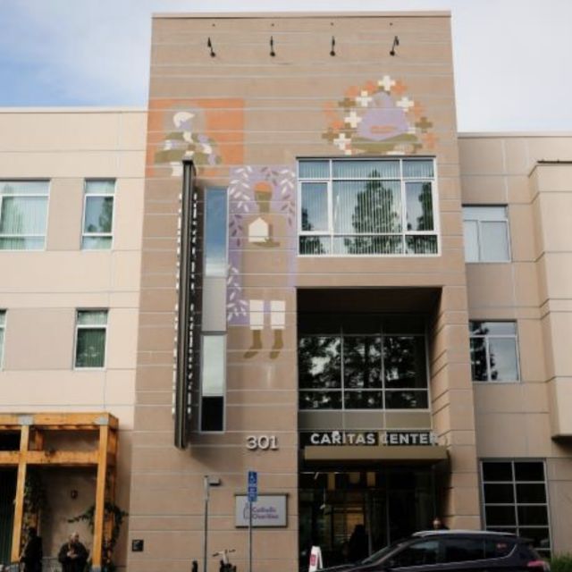 Two-tone beige apartment building with splashes of color