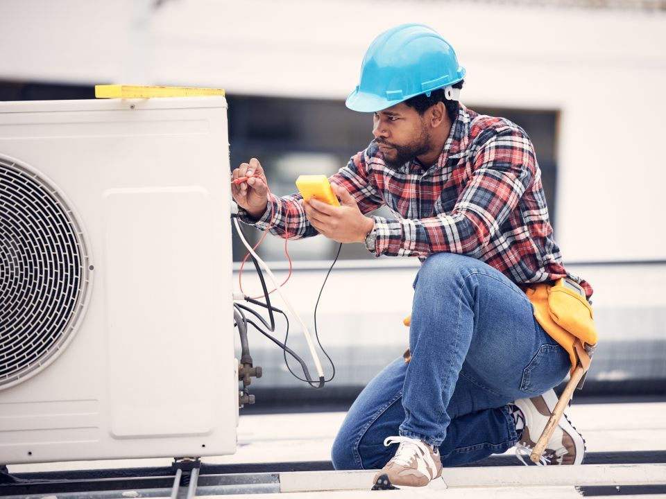 A construction worker working and testing equipment