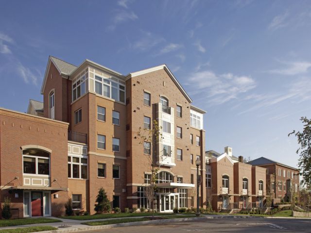 An apartment building with two different entrances and blue sky 